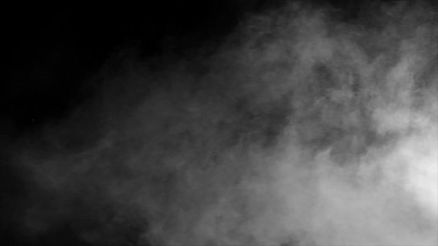 Spooky magic halloween. Atmospheric smoke VFX element. Abstract smoke cloud.  White smoke slowly floating through space against black bg
