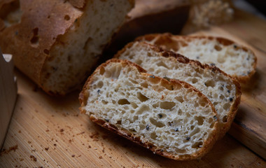 Fototapeta premium Sliced homemade bread on wooden board