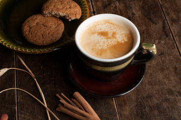 Cup of cofee and cereal cookies on the old wooden table