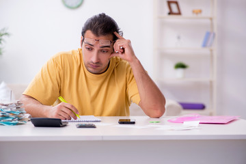 Young man in budget planning concept