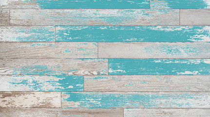 Fototapeta na wymiar Brown, turquoise, and teal wood boards on a wall. Vintage wood background with colored stain or paint.