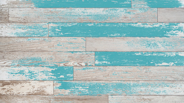 Brown, turquoise, and teal wood boards on a wall. Vintage wood background with colored stain or paint.