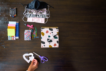 Back to School, stationery items display pencils, pen, scissiors, face mask, colour, pins
