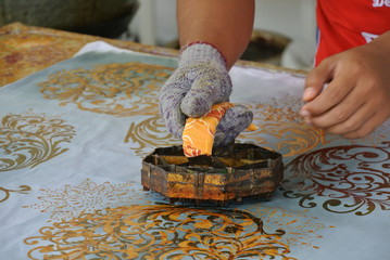 KUALA LUMPUR, MALAYSIA -JUNE 25, 2016: Handmade stamping batik. An artist press get batik pattern...