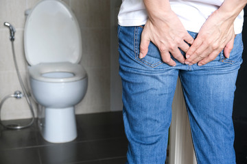 Men have abdominal pain and diarrhea, his hands close to the buttocks and hold toilet paper,...