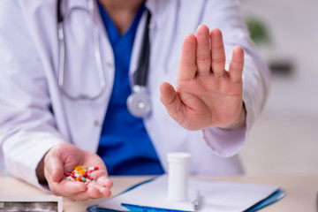 Old male doctor therapist working in the clinic