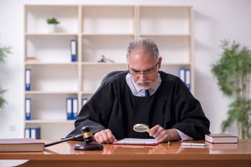 Old male judge working in courthouse