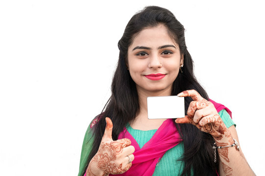 Young Indian woman holding ATM or visiting card with copy space.