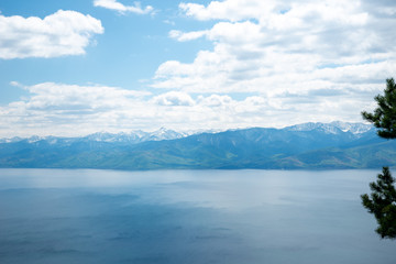 The coast of Lake Baikal on the Circum-Baikal Railway. Circum-Baikal railway tour in Siberia with trees, cliffs and mountains at coast. 
Baikal.
