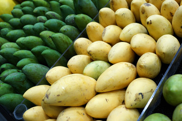 Fresh mangoes from Thailand display on market stall for sale