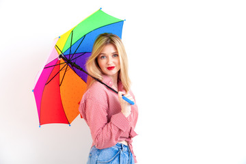 Young beautiful woman holding colored umbrella on white background