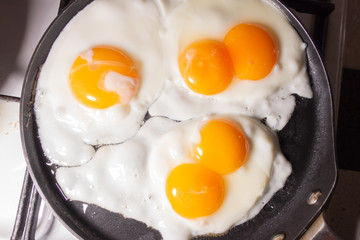 Fried eggs in a frying pan top view. An egg with two yolks.