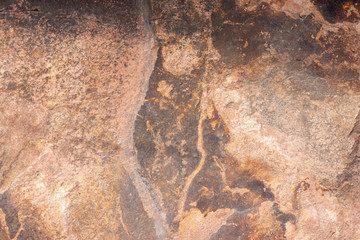 The surface of the old brown stone and cracks for background and textures.