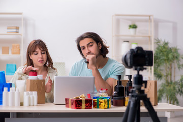 Young couple sales consultants recording video for their blog