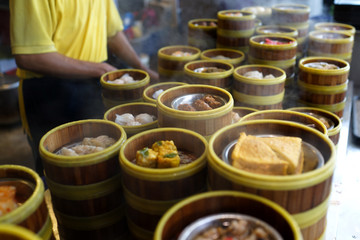 Variety of Chinese Dim Sum for breakfast. Dim Sum in bamboo steamer, traditional Chinese cuisine.