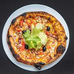 pizza on the black background, top view