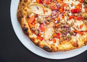 pizza on the black background, top view