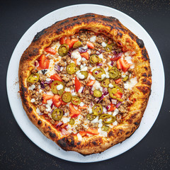pizza on the black background, top view