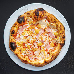 pizza on the black background, top view
