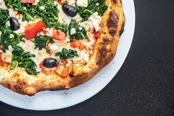 pizza on the black background, top view