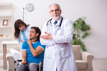 Two doctors visiting sick young man at home