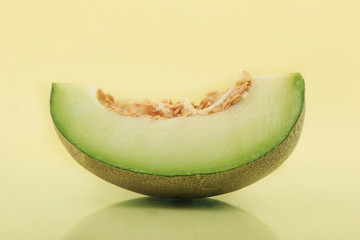 One slice of melon on the surface of the yellow base