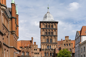 historic red brick buildings and city gate guard tower in the old town of Lubeck