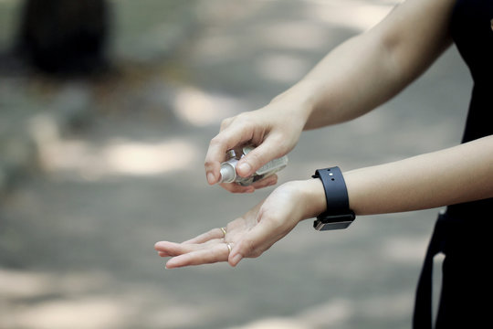 photo illustration of a woman hands using a hand sanitizer to prevent covid-19 virus