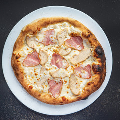 pizza on the black background, top view