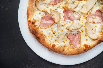 pizza on the black background, top view