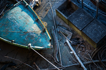 Top view of a old boats crashed to the surface of the shore, black albatross trapped in the ruins,...