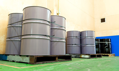 Low light inside of the old factory. Low view of large tanks chemical packaging.