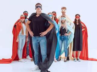 confident guy in a Superman Cape standing in front of his team