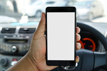 Close up adult hand holding a blank screen smartphone in car