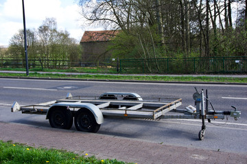 Close up shot of two axle trailer parked next to a street in Aachen, Germany