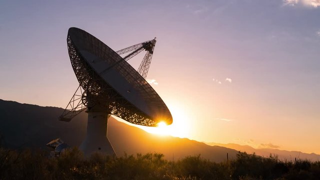 Time lapse of sun setting behind large radio observatory in Eastern Sierra, California