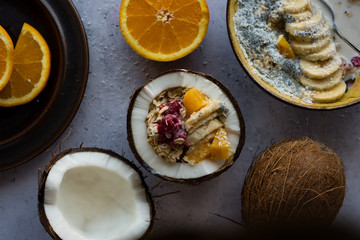 Oatmeal with chia seed, bananas and oranges served in a bowl