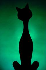 Black cat silhouette on green background