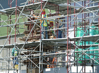 KUALA LUMPUR, MALAYSIA -MARCH 05, 2020: Construction workers installing & fabricating timber formwork at the construction site. The formworks made from timber and plywood. 