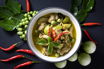 
Chicken Green Curry It is a popular Thai food. Placed on a black wooden table.