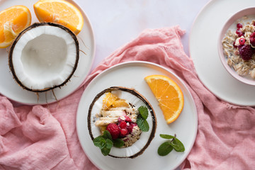Overhead view of oatmeal with chia seed, .raspberries, bananas and oranges