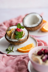 Overhead view of oatmeal with chia seed, .raspberries, bananas and oranges