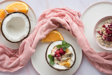 Overhead view of oatmeal with chia seed, .raspberries, bananas and oranges
