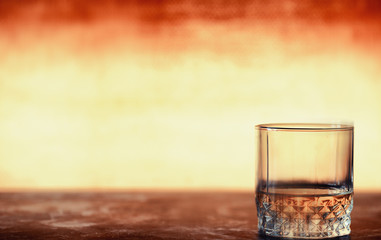 A glass of hard alcohol with ice on a bar counter. Whiskey with soda in a glass. Advertising alcoholic drink.