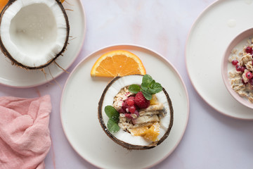 Overhead view of oatmeal with chia seed, .raspberries, bananas and oranges