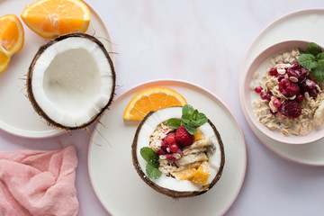 Overhead view of oatmeal with chia seed, .raspberries, bananas and oranges