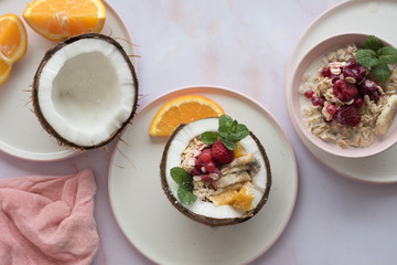 Overhead view of oatmeal with chia seed, .raspberries, bananas and oranges