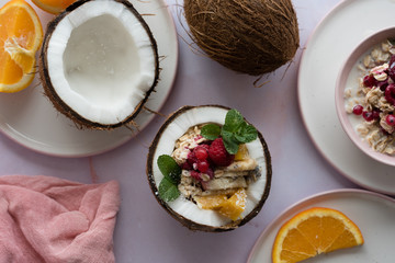 Overhead view of oatmeal with chia seed, .raspberries, bananas and oranges
