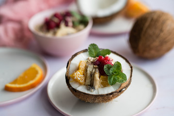 Overhead view of oatmeal with chia seed, .raspberries, bananas and oranges
