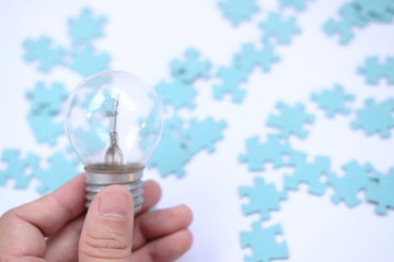 hand holding light bulb